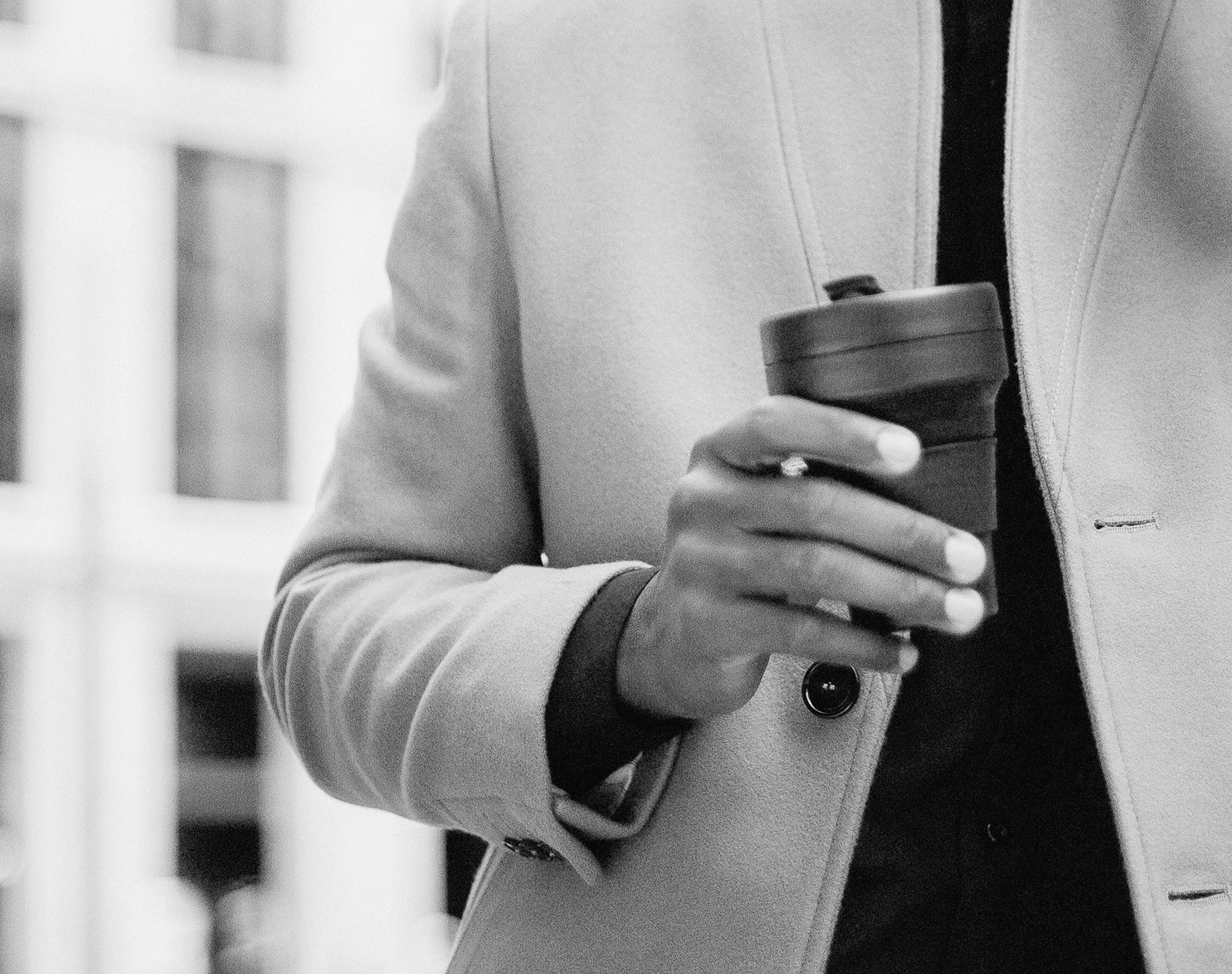 Man's hand holding coffee cup